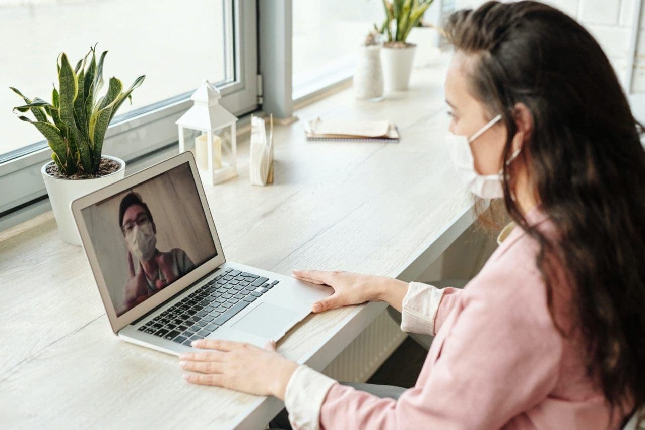 woman talking to her doctor via telehealth on computer